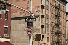 From Below Of One Way Traffic Signs On Crossroad With Modern High Buildings In Background In New York City