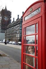 Teenager Girl and Famous English red phone with Big Ben in London, UK