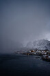 © Rafa Cortes/ADDICTIVE STOCK - From above of city harbor against snowy mountain ridges at horizon in overcast weather in Norway