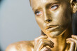 © de Art - beautiful model girl's, gold metallic skin make-up