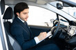 © Prostock-studio - Car Seller Sitting In Auto Taking Notes In Dealership