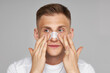 © Антон Пухов - Beauty saloon. Facial skin care. Man applying white nose patch. Closeup of pore cleansing. Cleaning strips