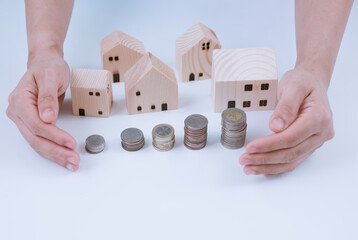 Mini wooden house with banknote and coin using as check up business financial, crisis, and property real estate, saving , investment concept