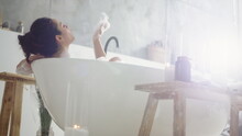 Close Up Sensual Woman Blowing Foam. Smiling Girl Having Fun With Foam In Bath.
