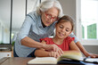 © goodluz - grandmother helping grandkid with homework