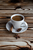 Fototapeta Kuchnia - espresso on wooden background with star anise and cinnamon