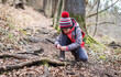 © _jure - Portrait of girl on hiking forest trip tying shoe laces.