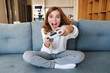 © Drobot Dean - Photo of excited nice girl smiling and playing video game with joystick
