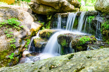 Wall Mural - Beautiful waterfall on small river in a park