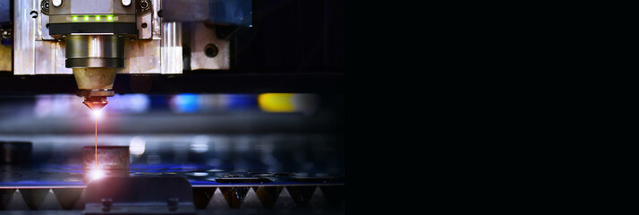 Wall Mural - industrial laser cut machine while cutting the sheet metal with the sparking light.copy space