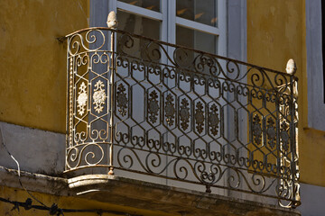 old building facade with iron balcony in Olhao, Algarve, Portugal