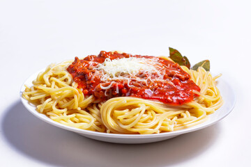 Delicious Spaguetti Pasta with bolognesa tomato sauce and chopped meat. Adorned with cheese and Laurel leaf