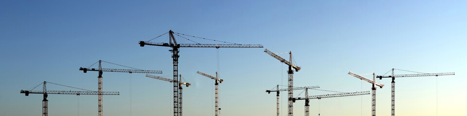 wide-format panorama with construction cranes