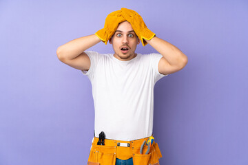 Wall Mural - Young electrician man over isolated on purple background with surprise facial expression