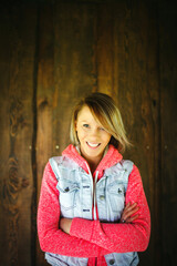 Wall Mural - Young woman in front of wooden wall