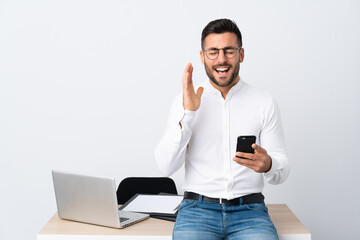 Wall Mural - Young businessman holding a mobile phone laughing