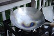 Seasoning the traditional Chinese Wok, selective focus