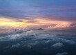 Beautiful clouds at sunrise in the skies with the peak of a mountain in view