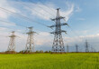 © yelantsevv - Electrical net of poles on a panorama of blue sky and green meadow