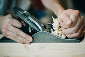 Hands on a vintage woodworking tool