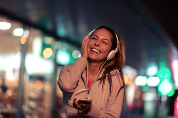 Sticker - Young woman running at night.