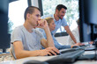 © auremar - row of students using computers watchful teacher behind