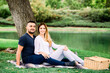 © Hayk Shalunts - Young woman and man spending their time at the park, having a picnic.