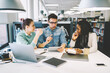 © BullRun - Coworkers discussing startup project while checking information using modern digital devices and wireless connection