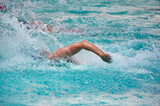Fototapeta Łazienka - Athlete training swimming in wave pool at gym blue water splashing competition