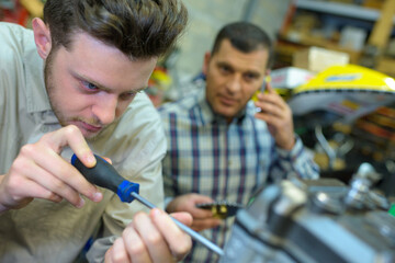 male machinist working on machine part