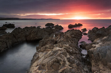 Wall Mural - Sunset over a rocky beach on Australia