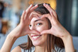 © Joe-L - Beautiful woman looking through heart gesture made with hands