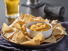 Mexican Hot Queso Cheese Dip With Corn Tortilla Chips On Plate