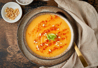 Wall Mural - Autumn pumpkin soup with smoked paprika, pine nuts, vegetarian dish