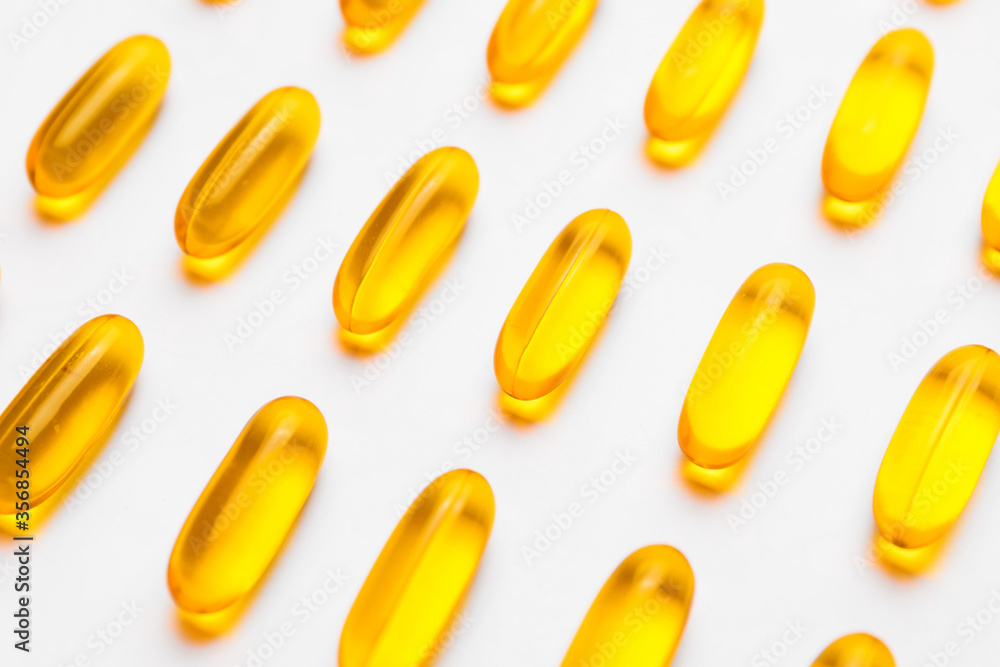 Fish oil capsules on white background