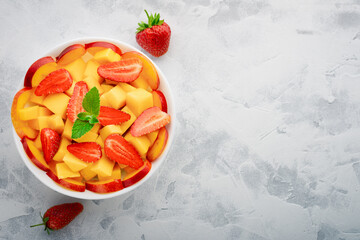 Wall Mural - Fruit salad made of avocado, strawberry and peach with place for text