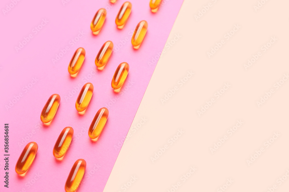 Fish oil capsules on color background