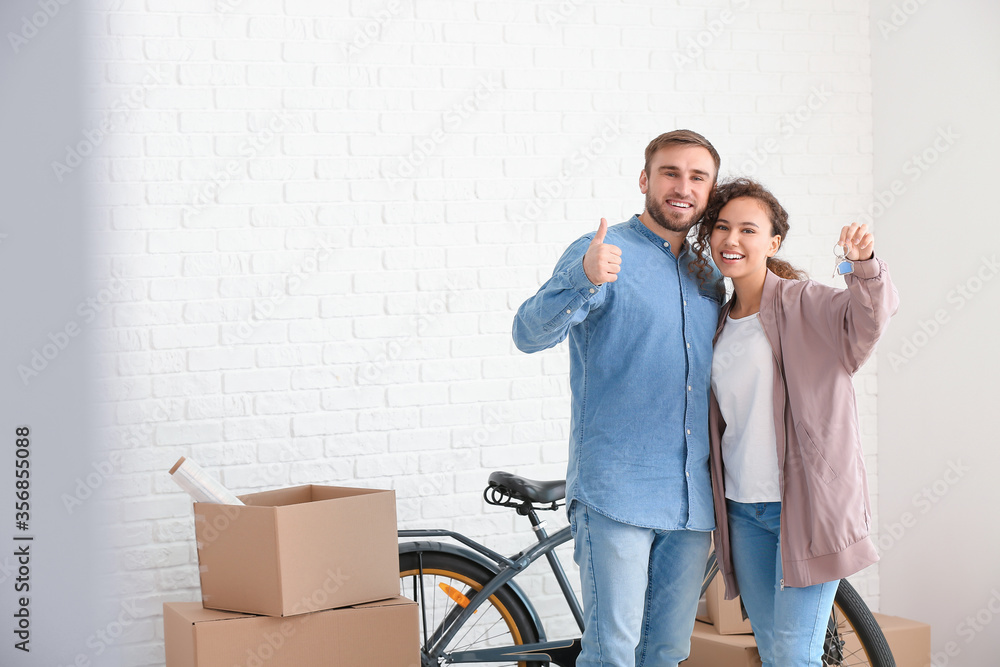 Young couple in their new flat on moving day