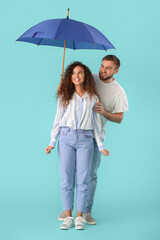 Canvas Print - Happy young couple with umbrella on color background