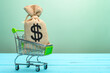 © Freer - shopping cart with a bag with US dollar symbol