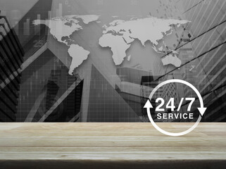 24 hours service icon on wooden table over black and white world map, city tower and skyscraper background, Business full time service concept, Elements of this image furnished by NASA