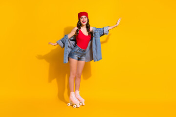 Sticker - Full body photo of positive cheerful sporty youngster girl ride roller skates hold hands imagine she fly wear red headwear tank-top denim isolated over bright color background