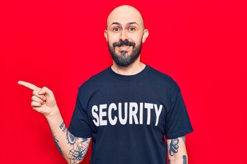 Poster - Young handsome man wearing security t shirt smiling happy pointing with hand and finger to the side