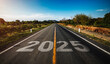 © ATKWORK888 - 2025 written on highway road in the middle of empty asphalt road at golden sunset and beautiful blue sky. Concept for new year 2025.