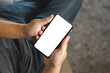© onephoto - Top view Mockup image hand using a smartphone man Holding Cell Phone With Blank Screen