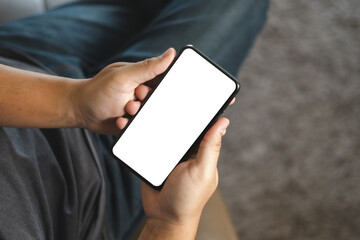 Wall Mural - top view mockup image hand using a smartphone man holding cell phone with blank screen