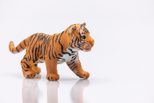 Close Up Of A Baby Tiger From A Plastic Toy Isolated On A White Background