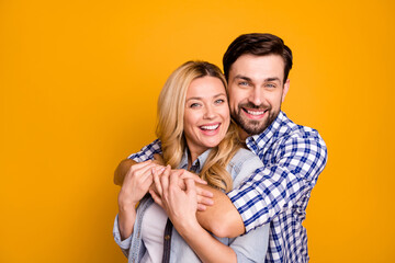 Canvas Print - Photo beautiful wife lady handsome husband guy couple hugging good mood in love perfect pair hold arms wear casual shirts clothes isolated yellow color background