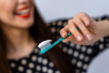 Canvas Print - Image of pretty female holding teeth brush in hands. Selective focus. Teeth care concept. Oral care concept.