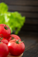 Fresh juicy ripe pink tomatoes with green ponytails, a new crop of organic vegetables